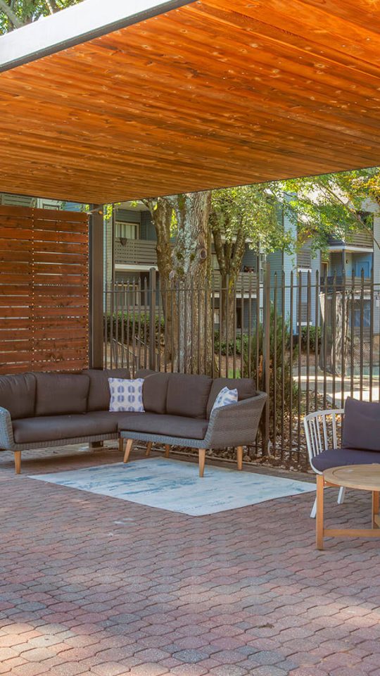 a patio with a pergola and furniture at The  Jaxon