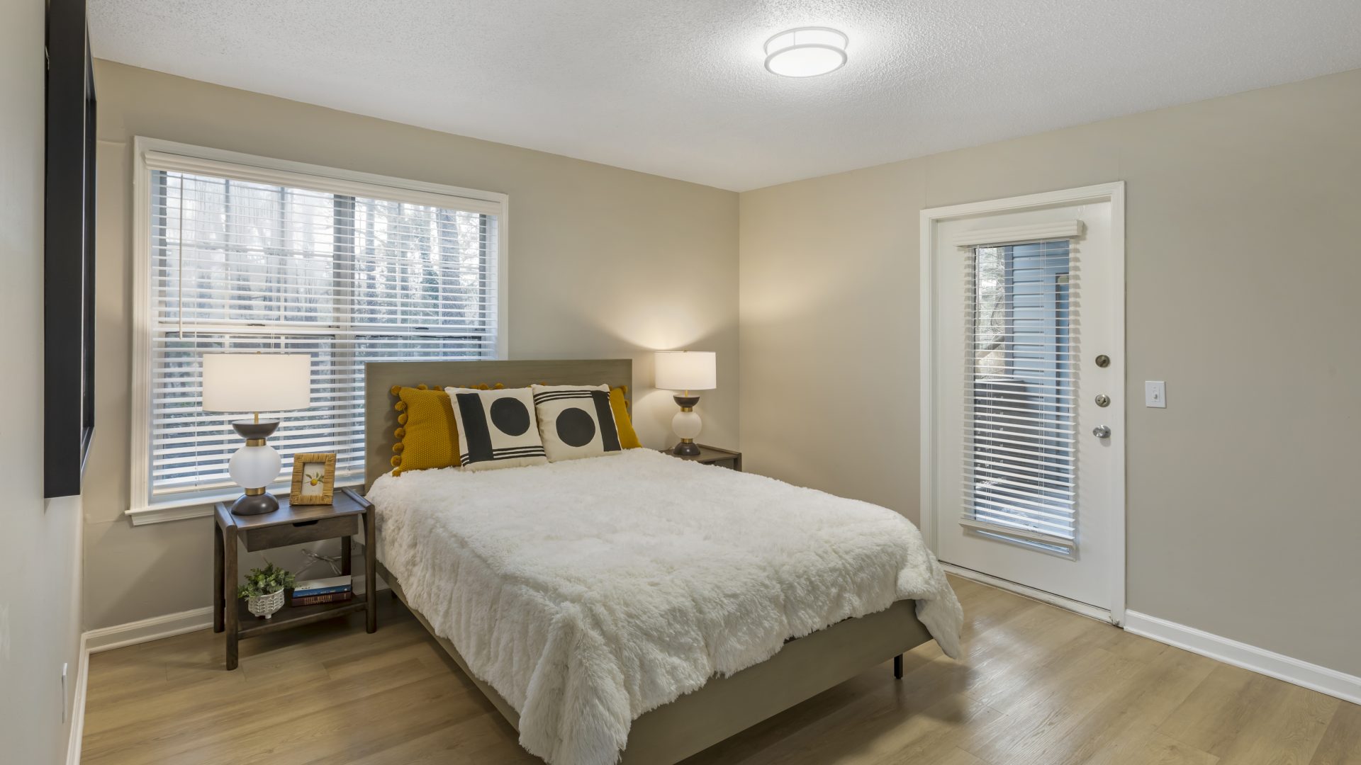 a bedroom with hardwood floors and a large bed at The  Jaxon