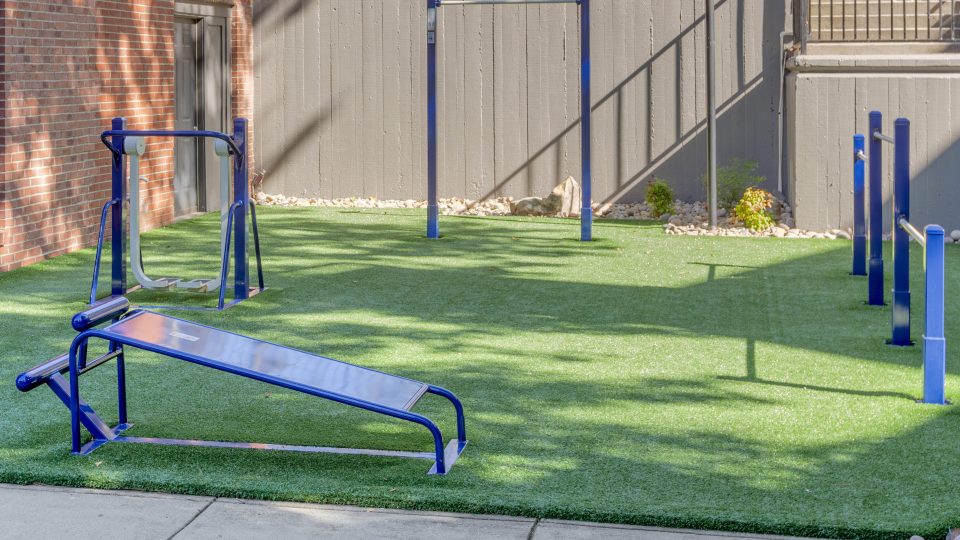 a gym set up in a backyard with artificial grass at The  Jaxon